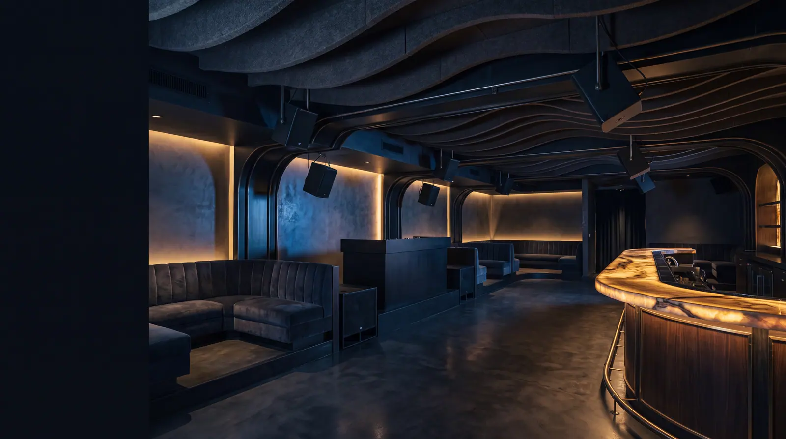 Design concept: an empty nightclub lounge before opening with loudspeakers flown discreetly from the ceiling structure.